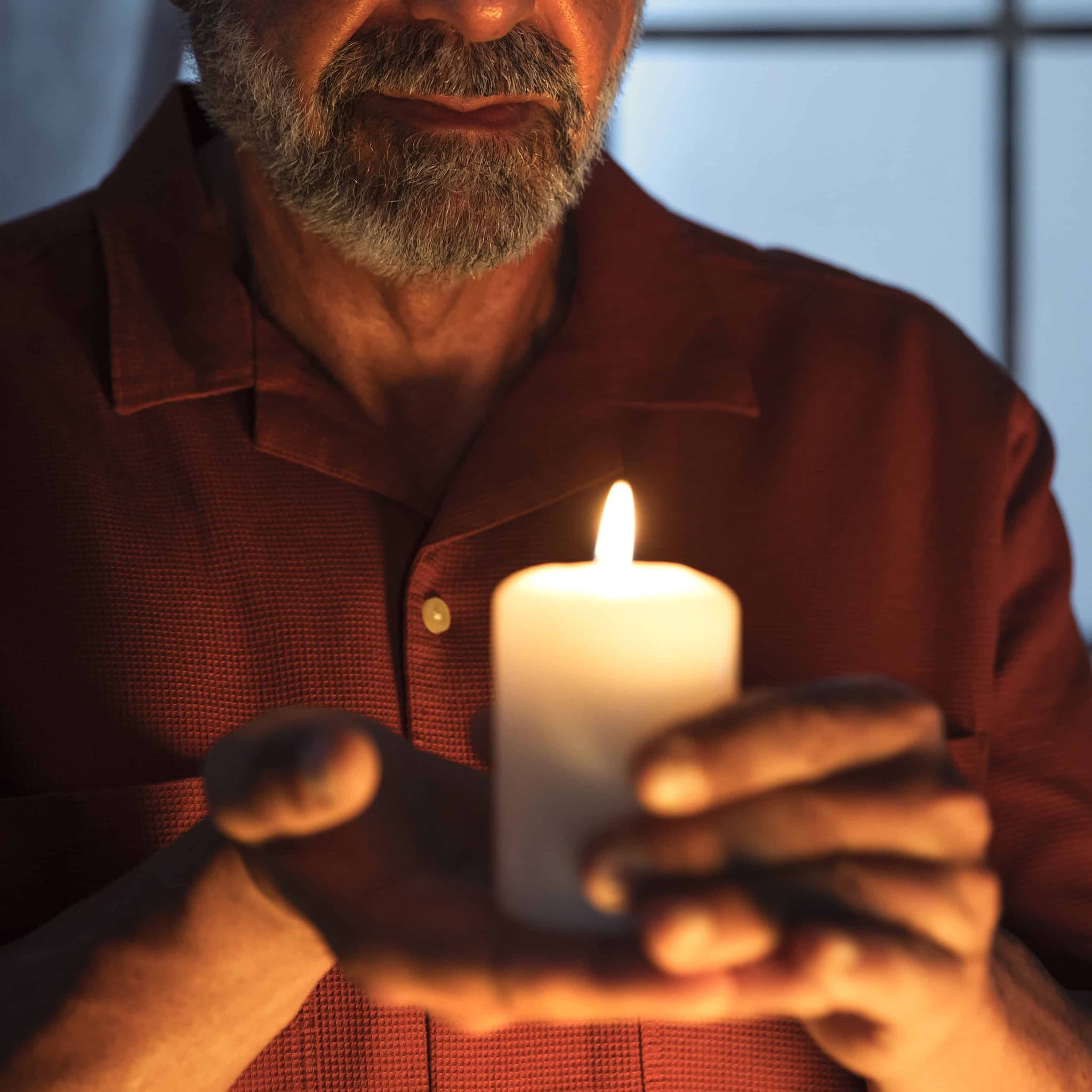 Senior man holding candle